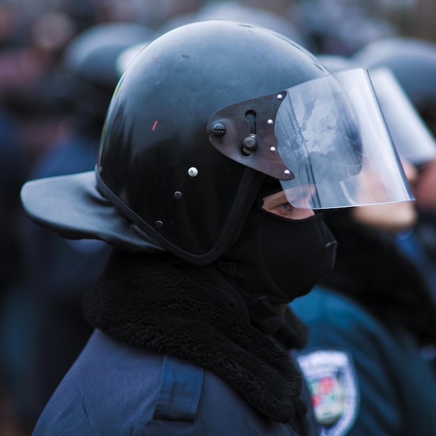 LUHANSK, UKRAINE - APRIL 5, 2014 A policeman at a rally stands in a helmet, a close-up portrait.