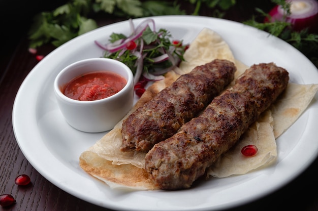 Lula kebab with herbs and sauce