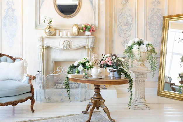 Luluxury rich sitting room interior in beige pastel color with antique expensive furniture in baroque style. walls decorated with stucco and frescoes