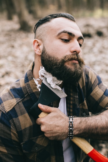 Lumberjack shaving with axe