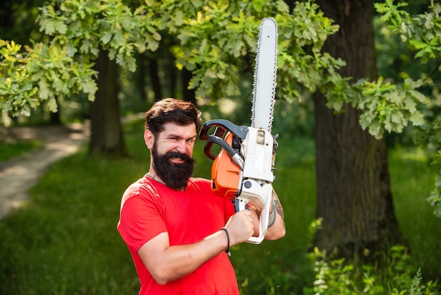 Lumberjack worker walking in the forest with chainsaw agriculture and forestry theme illegal logging...