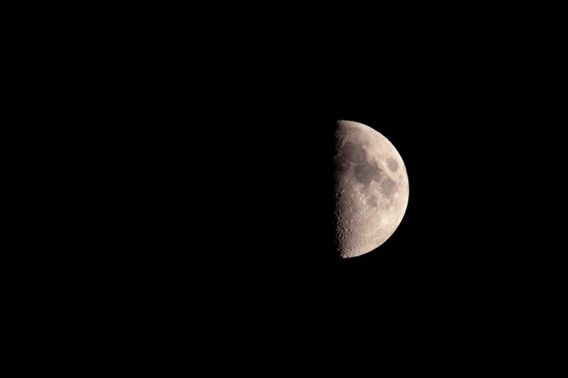 A lunar eclipse the moon is half visiblethe background is black