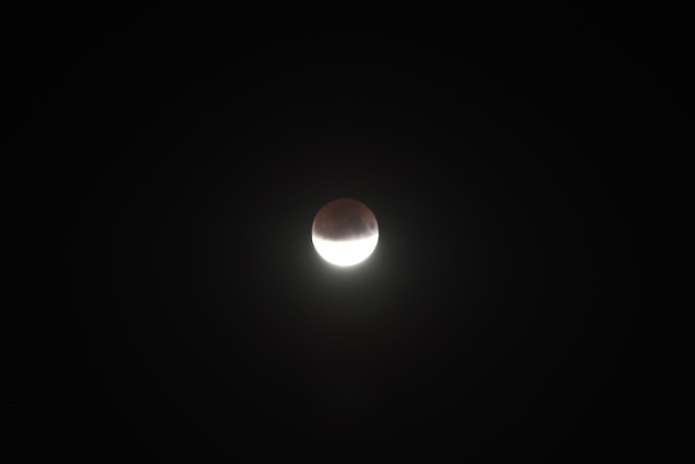 Lunar moon half eclipse on black night sky background