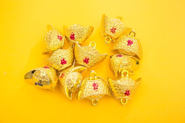 Lunar new year decoration with lucky gold bar isolated on yellow . tet holiday