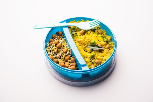 Lunch Box or Tiffin for Indian kids, hot Poha made using beaten rice and spices, accompanied with sprouts