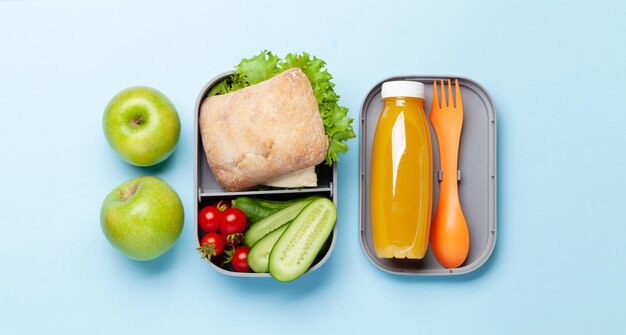 Lunch box with sandwich vegetables and juice