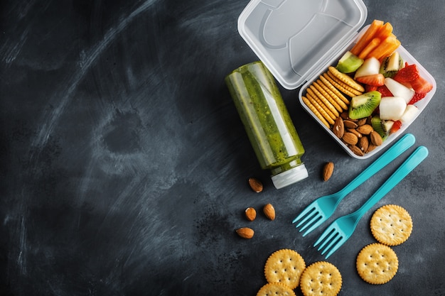 Lunch to go with fruits and vegetables in box. View from above.