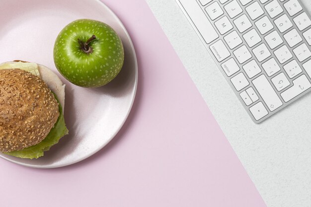 Lunch at work place healthy sandwich near laptop on work table. Home food for office concept