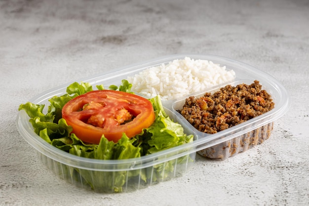 Lunchbox with lettuce salad with tomato rice and ground beef