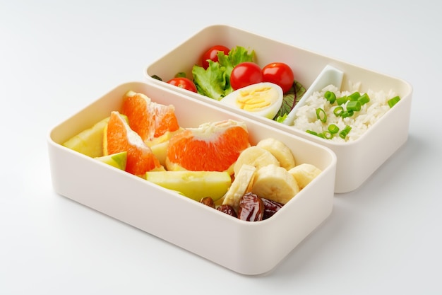 Lunchboxen met gezond voedsel geïsoleerd op wit