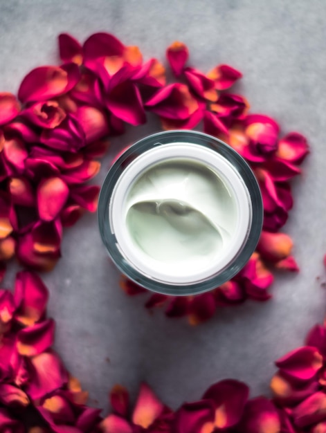 Luxe face cream and rose petals cosmetics with flowers styled beauty concept