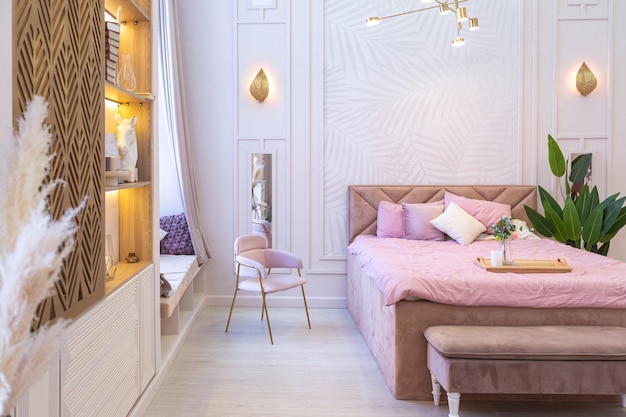 Luxe moderne slaapkamer interieur van een duur ruim licht stijlvol appartement. gestoffeerde meubels en decoratieve verlichting, zachte pastelkleuren en gezellige sfeer