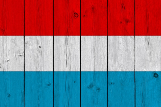 Luxembourg flag painted on old wood plank