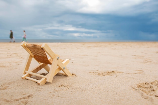 A luxurious deck chair on the shore by the sea to relax and enjoy the view of the summer seascape