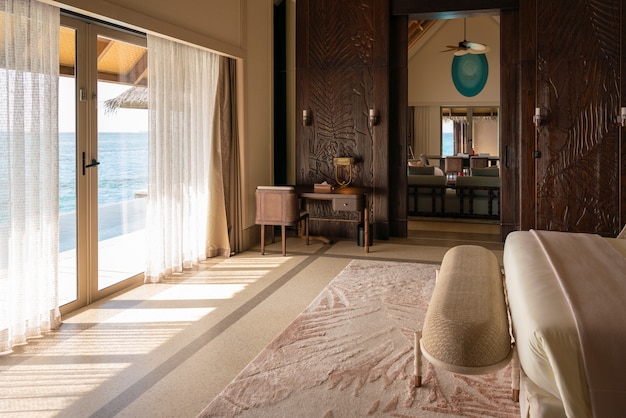 Luxurious interior of a very expensive rich water villa in the Maldives, decorated with natural wood.