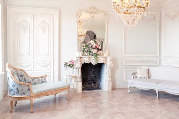 Luxurious light interior of the living room in the baroque style as in a royal castle with old stylish vintage furniture