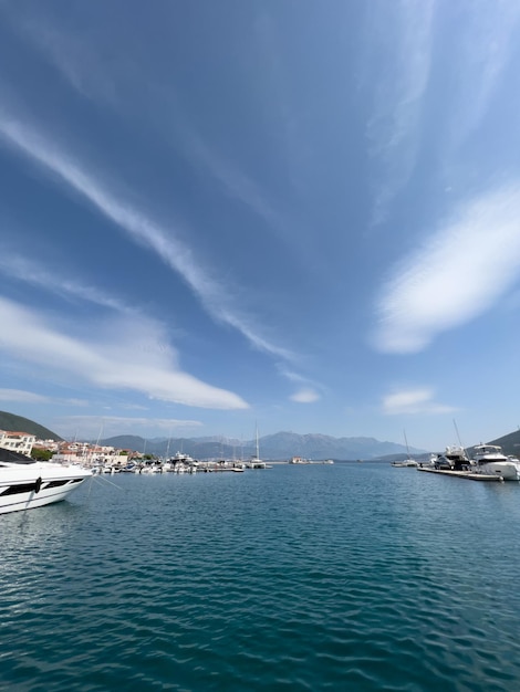 Luxurious marina at the foot of the mountains with expensive yachts against the backdrop of cirrus