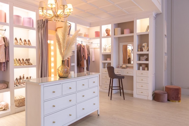 Luxurious modern dressing room interior in a chic bright apartment in pink. trendy lighting, stylish luxury design and white furniture