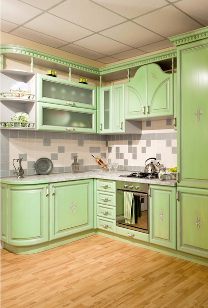 Luxurious new green kitchen with modern appliances