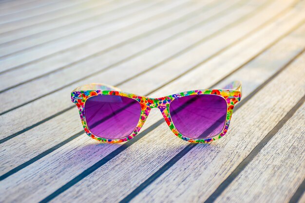 Luxurious purple glasses lie on the deck of the yacht while traveling