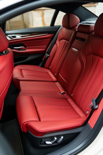 Luxurious red leather back passenger seats in stylish luxury car