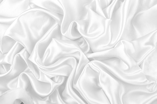 Luxurious of smooth white silk or satin fabric texture background