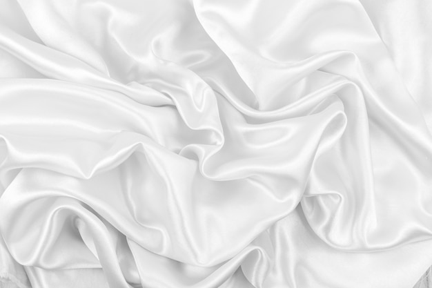 Luxurious of smooth white silk or satin fabric texture background