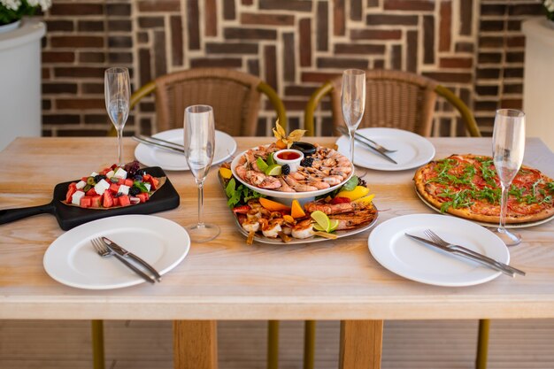 Luxurious table in the restaurant On the table is a plate with seafood pizza vegetable