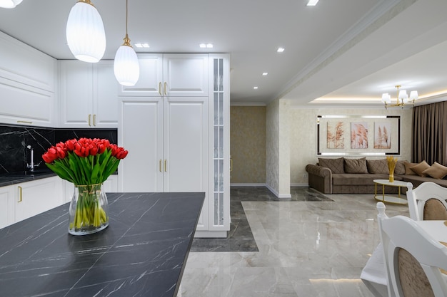 Luxurious white modern domestic kitchen with black marble worktop