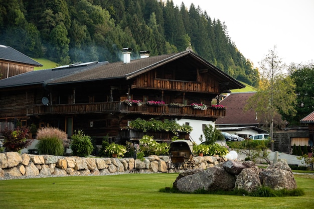 luxurious wooden chalet house on austrian mountains alps between trees and bushes