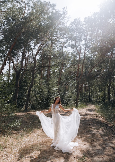 Luxurious young bride in an expensive fashionable wardrobe poses for a wedding photo shoot in a luxury resort town