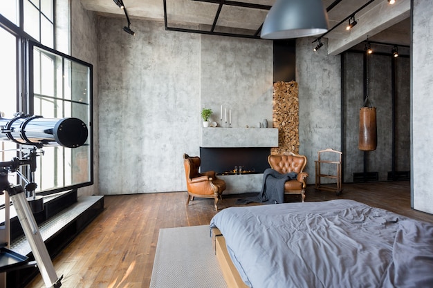 Luxury apartment in a loft style in dark colors. Stylish modern bedroom