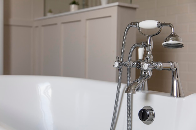 Luxury bathroom interior with classic rolltop bath tub and vintage tap