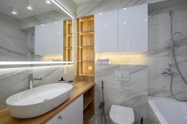 Luxury bathroom interior with marble tiles on the walls