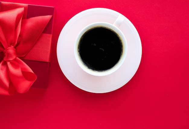 Luxury beauty gift box and coffee on red flatlay