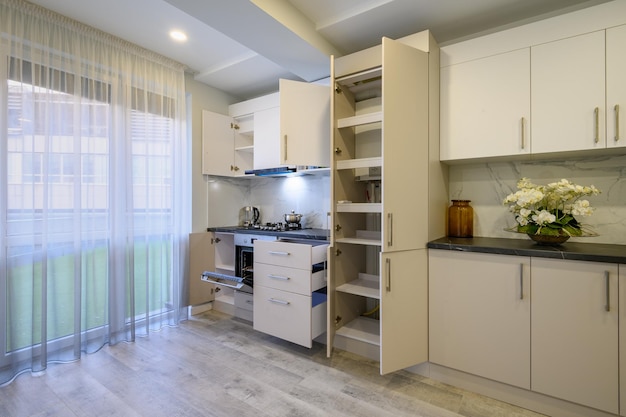 Luxury beige and cream kitchen interior details some drawers retracted