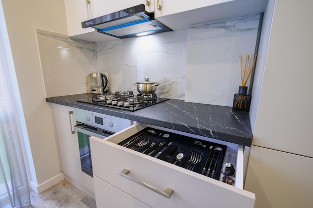 Luxury beige and cream kitchen interior details some drawers retracted