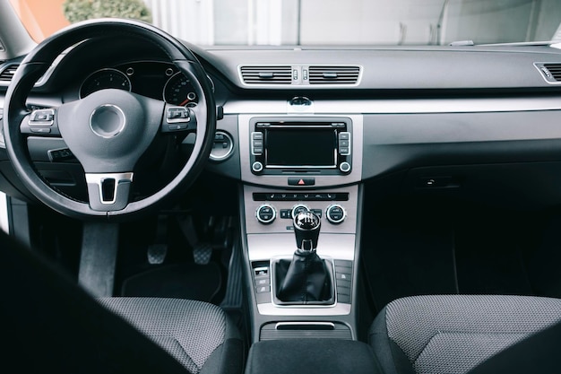 Luxury black car interior, climate control, air ducts, deflectors on the car panel.