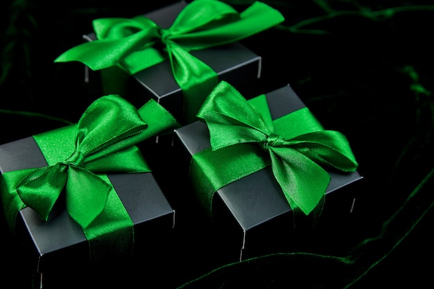 Luxury black gift boxes with green ribbon