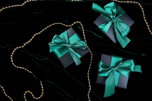 Luxury black gift boxes with green ribbon