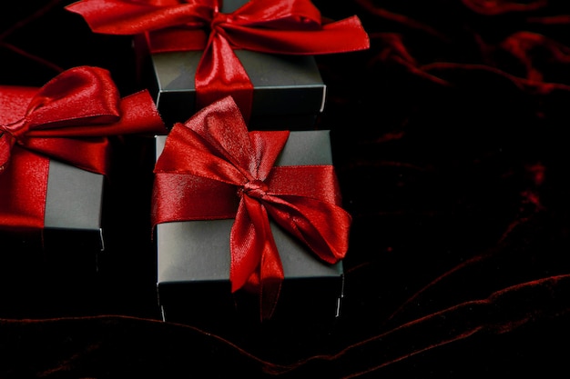 Luxury black gift boxes with red ribbon