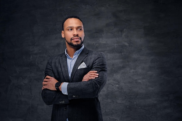 A luxury black male dressed in a suit over grey vignette background.