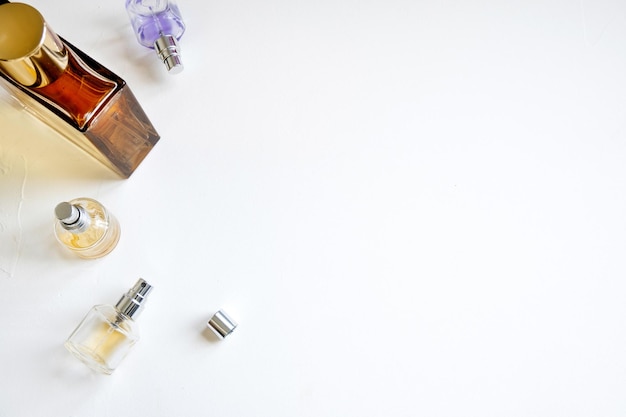 Luxury bottles of different forms with perfumes of elite and niche perfumes on a white background