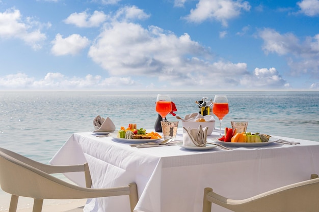 Luxury breakfast food on white table with beautiful tropical sea view background, morning summertime