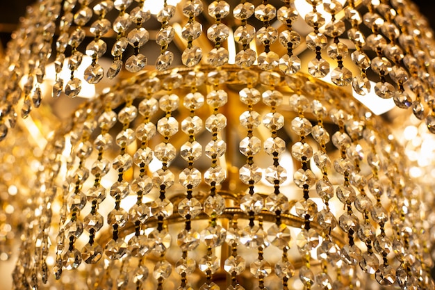 Luxury chandelier close-up. Gold sparkling chandelier in an expensive luxury hotel. Interior luxury