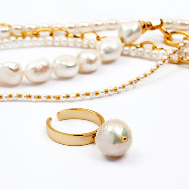 Luxury elegant baroque pearl ring with necklaces on white background. Close-up shot. Selective focus