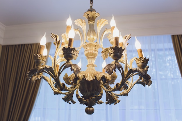 Luxury expensive chandelier hanging under ceiling in palace