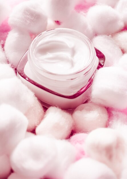 Luxury face cream for sensitive skin and pink cotton balls on background spa cosmetics and natural skincare beauty brand product