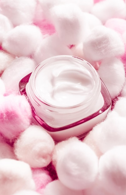 Luxury face cream for sensitive skin and pink cotton balls on background spa cosmetics and natural skincare beauty brand product