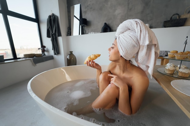 Luxury fashion woman in the morning take breakfast lying in bath